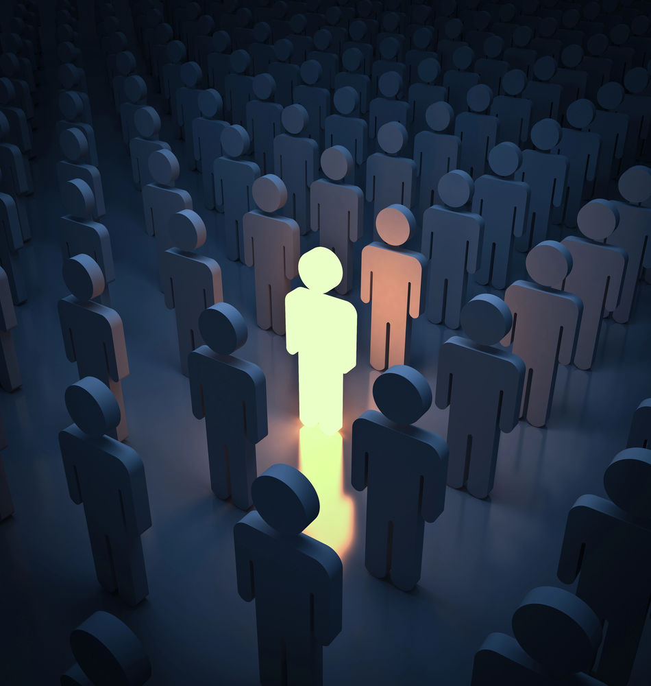 A figure glows amid a crowd of shadowy figures, representing the benefits of search engine optimization for authors when they stand out in a crowd for better searchability.